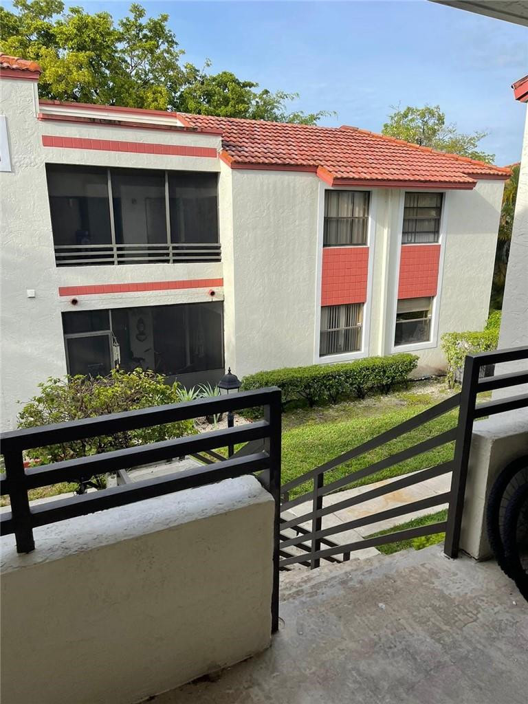 1112 North Hiatus Road, Unit 1112 Pembroke Pines, FL 33026 - Photo 40 of 48 a front view of a house with a garden