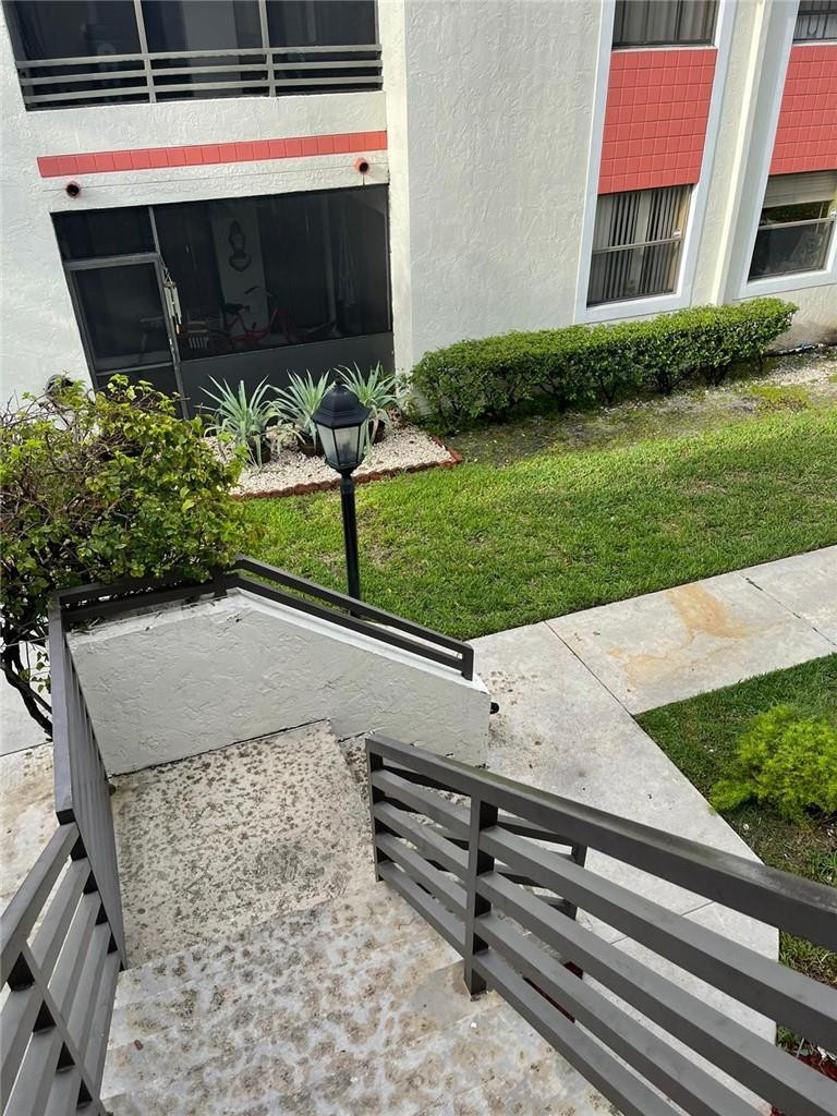 1112 North Hiatus Road, Unit 1112 Pembroke Pines, FL 33026 - Photo 41 of 48 a view of a building with a yard