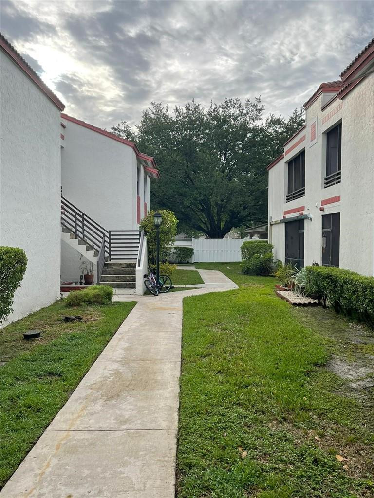 1112 North Hiatus Road, Unit 1112 Pembroke Pines, FL 33026 - Photo 42 of 48 a view of a house with a yard