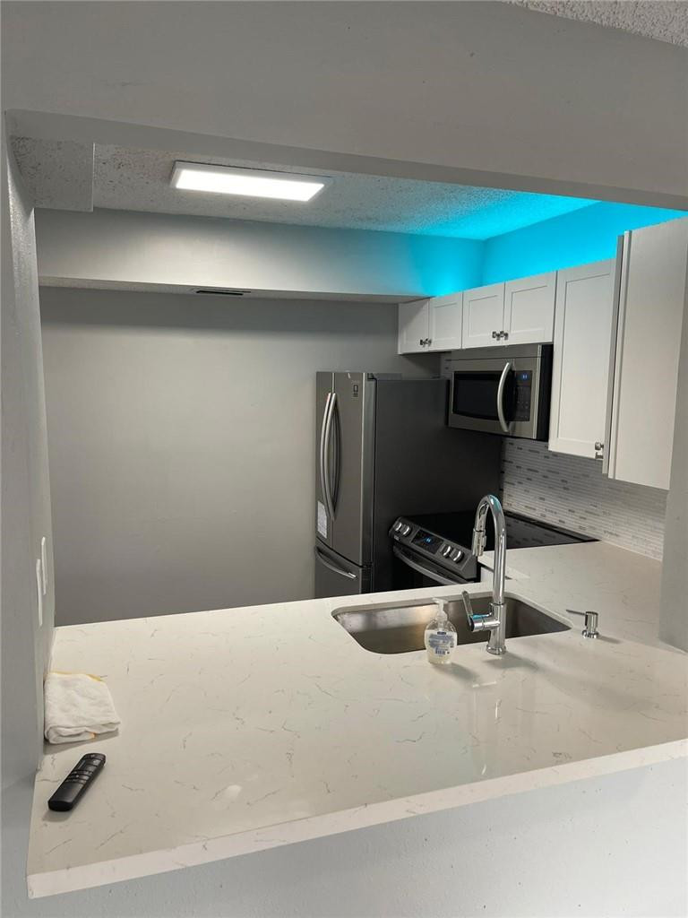 1112 North Hiatus Road, Unit 1112 Pembroke Pines, FL 33026 - Photo 8 of 48 a bathroom with a sink and a mirror