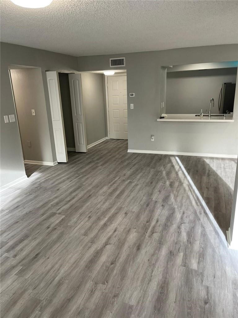 1112 North Hiatus Road, Unit 1112 Pembroke Pines, FL 33026 - Photo 9 of 48 a view of a hallway with wooden floor