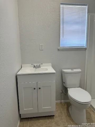 a white toilet sitting next to a bathroom sink