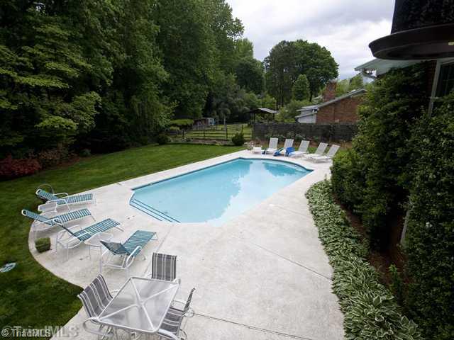 5609 Tower Road Greensboro, NC 27410 - Photo 11 of 12 Swimming Pool/Hot Tub/Sauna. The view from the balcony in the great room! Note the garden space and rose garden along the fence.