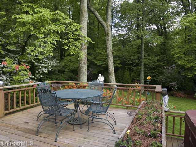 5609 Tower Road Greensboro, NC 27410 - Photo 9 of 12 Exterior Back. Multilevel decking overlooks the fabulous gardens. Hard to believe that you are in the city! Note the two trees which are perfect for a hammock and hot tub to the right.
