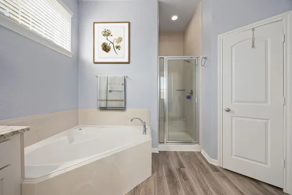 a bathroom with a bathtub and a shower
