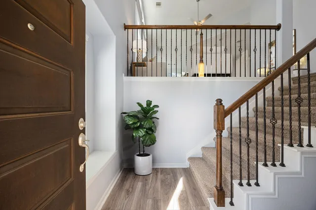 a view of staircase with wooden floor and a potted plant