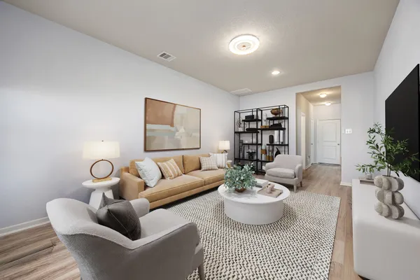 a living room with furniture and a wooden floor