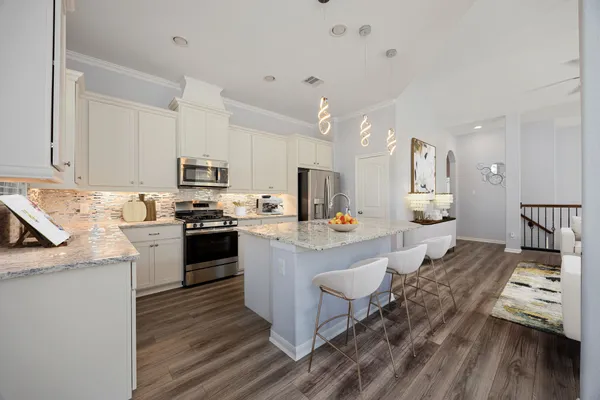 a kitchen with counter top space a sink appliances and cabinets