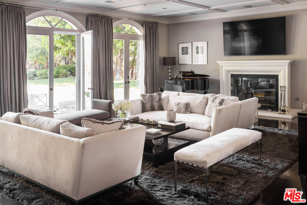 11972 Lockridge Road Studio City, CA 91604 - Photo 13 of 29 a living room with fireplace furniture and a flat screen tv