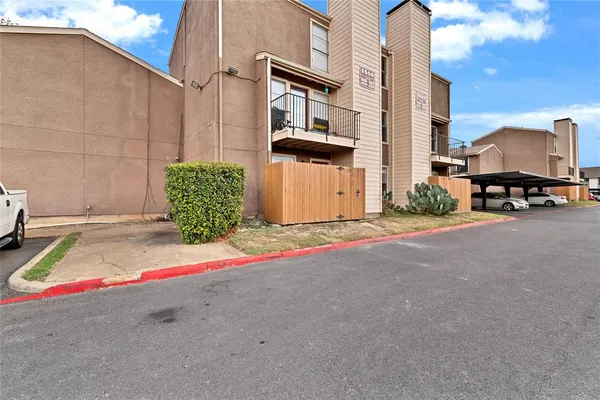 a front view of a house with garden and plants