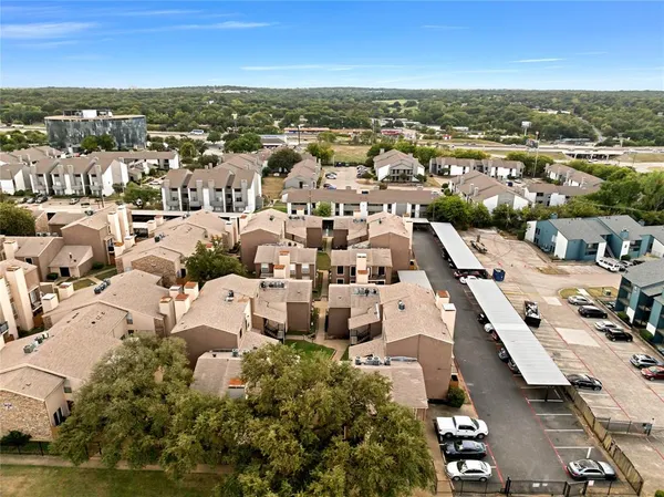 an aerial view of residential building with parking