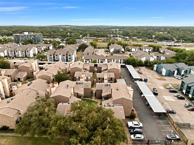 an aerial view of residential building with parking