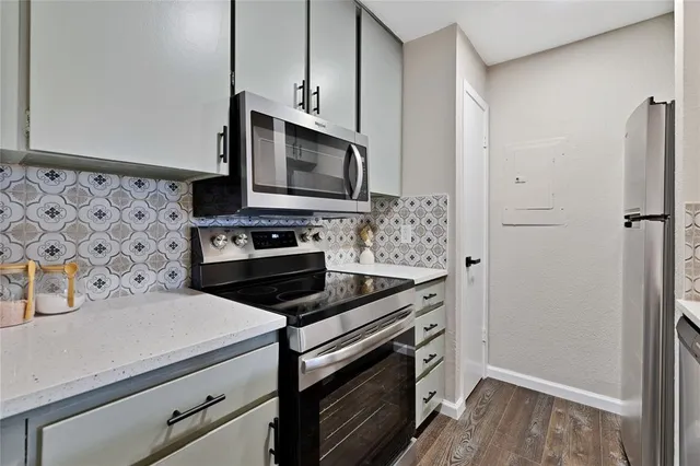 a kitchen with appliances a sink and cabinets