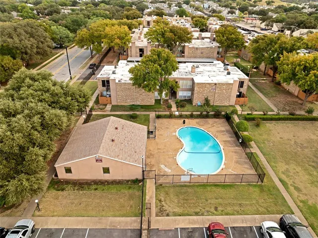 an aerial view of residential houses with outdoor space