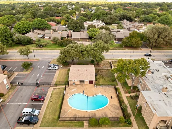 an aerial view of residential building with parking