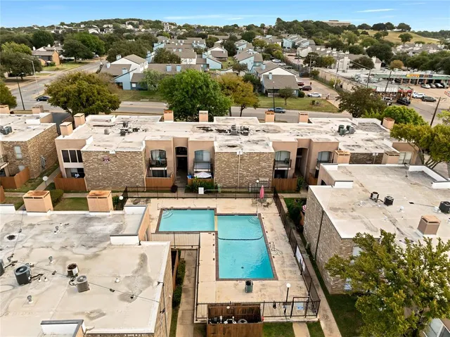 an aerial view of residential houses with outdoor space