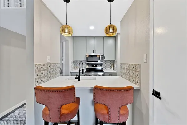 a kitchen with a sink and a refrigerator