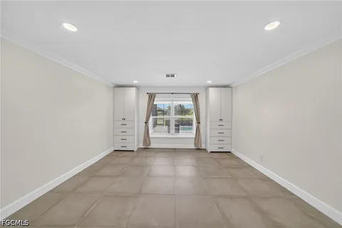 an empty room with closet and a ceiling fan