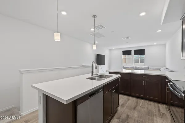 a kitchen with appliances cabinets a sink and a stove