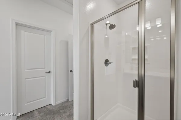 a en suite bathroom with a granite countertop sink mirror and vanity