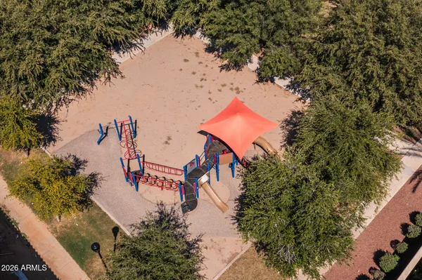 an aerial view of a house with outdoor space and swimming pool
