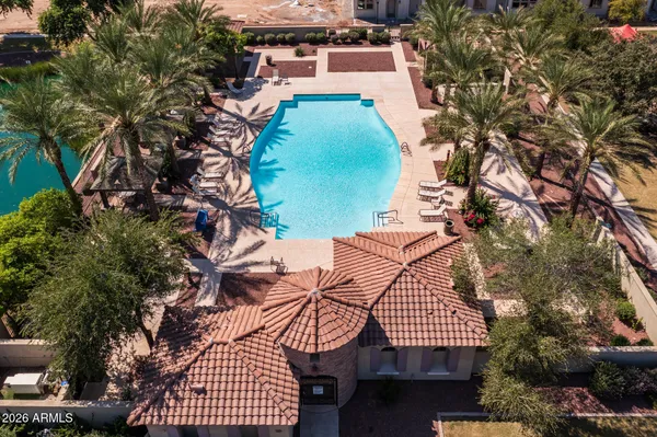 an aerial view of a house with outdoor space and lake view