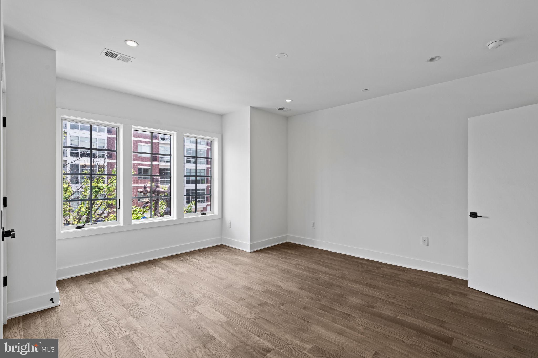 742 South Broad Street Philadelphia, PA 19146 - Photo 22 of 41 a view of an empty room with wooden floor and a window