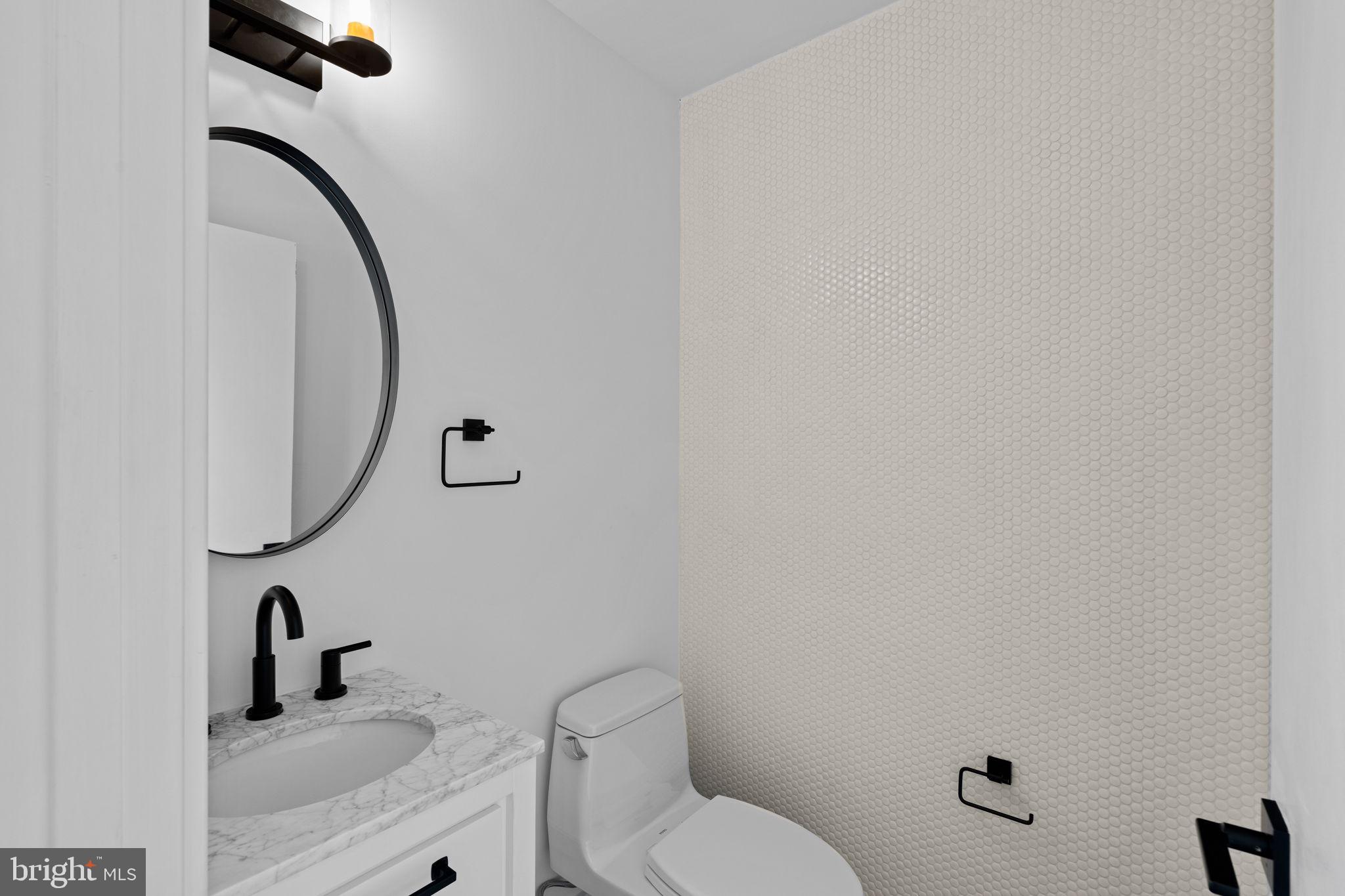 742 South Broad Street Philadelphia, PA 19146 - Photo 37 of 41 a bathroom with a toilet sink and mirror