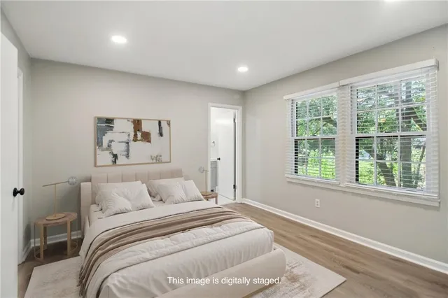 a bedroom with a large bed and a window