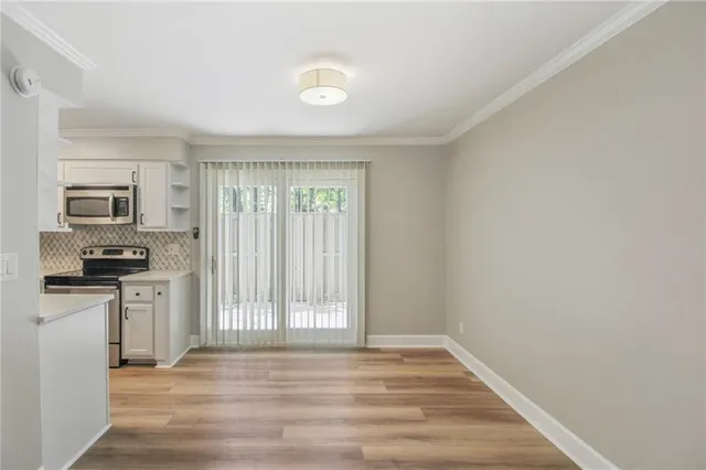 a view of a kitchen with a sink a refrigerator and microwave