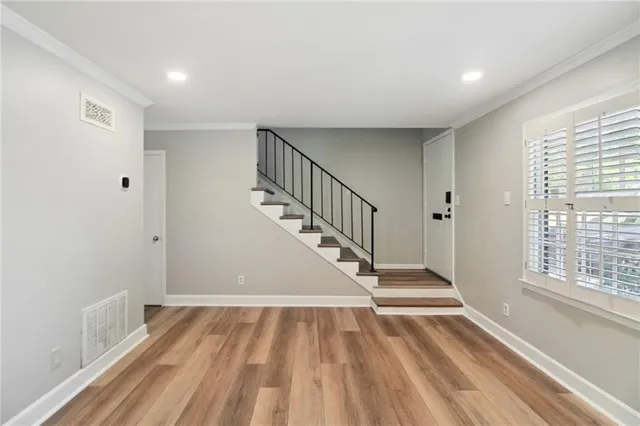 a view of entryway with wooden floor and stairs