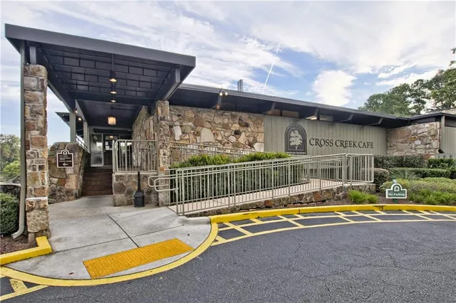 a view of swimming pool with outdoor seating and yard in back