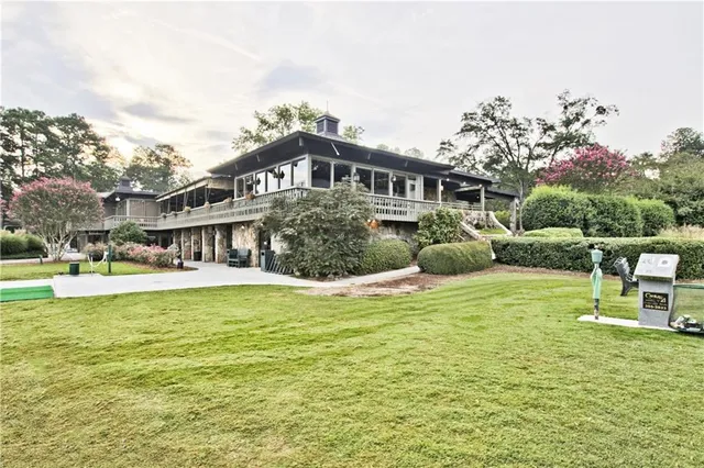 a view of a house with a yard patio and sitting area