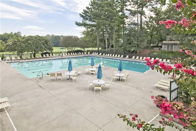 a view of a patio with a table and chairs and potted plants