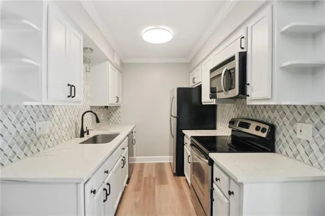 a kitchen with a sink a stove and cabinets