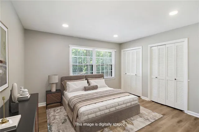 a bedroom with a large bed and a window