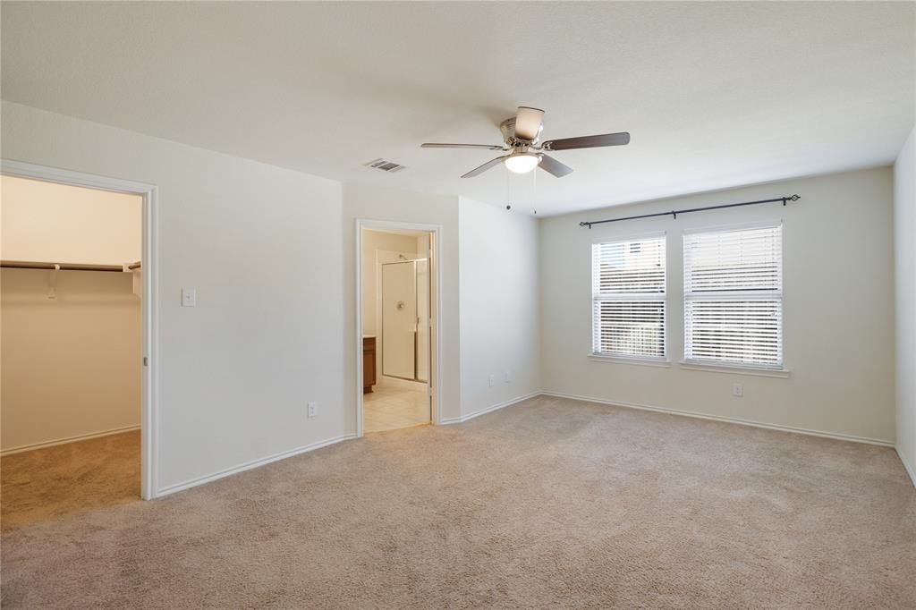 910 Amber Street Princeton, TX 75407 - Photo 12 of 24 a view of a room with a ceiling fan and a window
