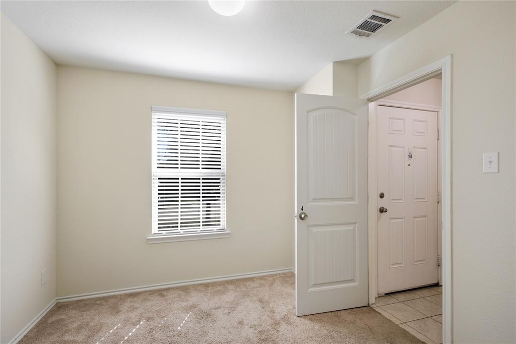 910 Amber Street Princeton, TX 75407 - Photo 17 of 24 a view of an empty room with a window