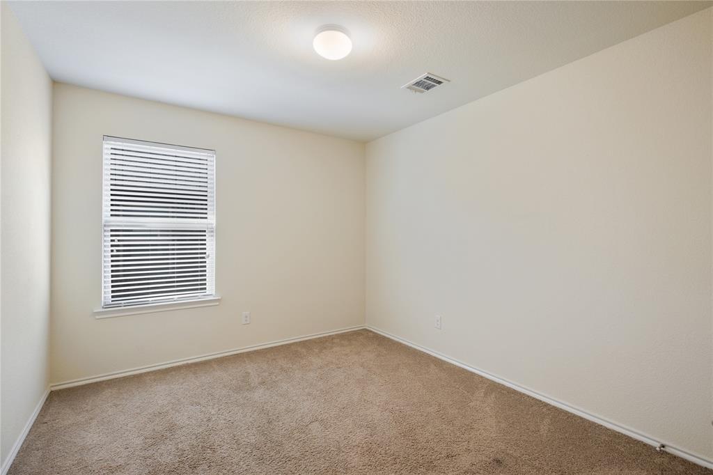 910 Amber Street Princeton, TX 75407 - Photo 18 of 24 an empty room with a window