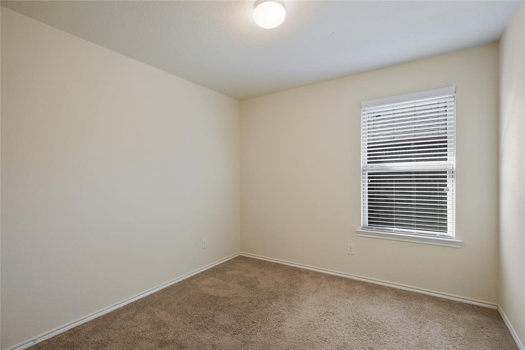 910 Amber Street Princeton, TX 75407 - Photo 19 of 24 a view of an empty room with a window