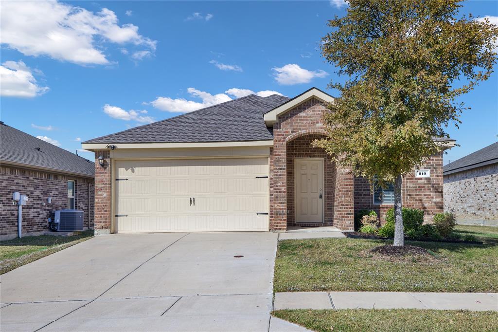 910 Amber Street Princeton, TX 75407 - Photo 2 of 24 a front view of a house with a yard and garage