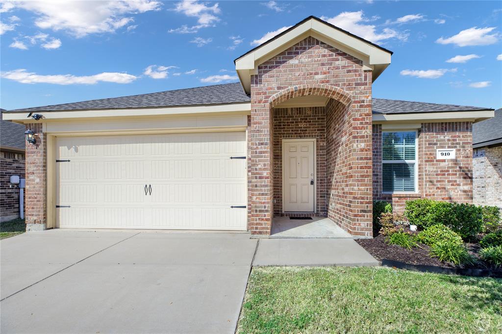 910 Amber Street Princeton, TX 75407 - Photo 4 of 24 a front view of a house with a garden