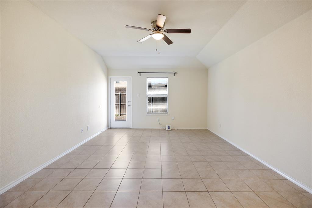 910 Amber Street Princeton, TX 75407 - Photo 6 of 24 an empty room with windows and ceiling fan