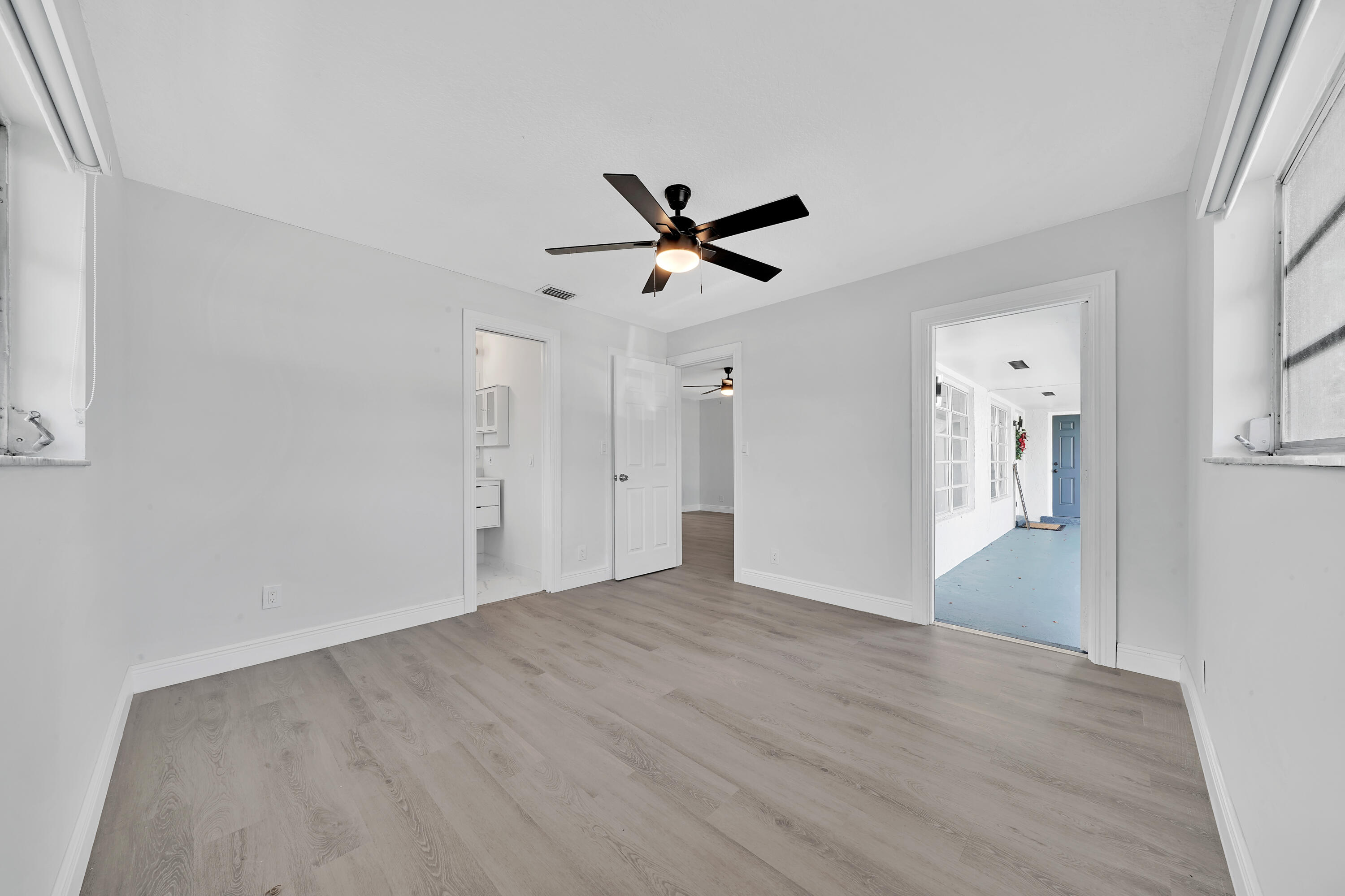 104 Palamino Circle Boca Raton, FL 33487 - Photo 12 of 34 wooden floor in an empty room with a window