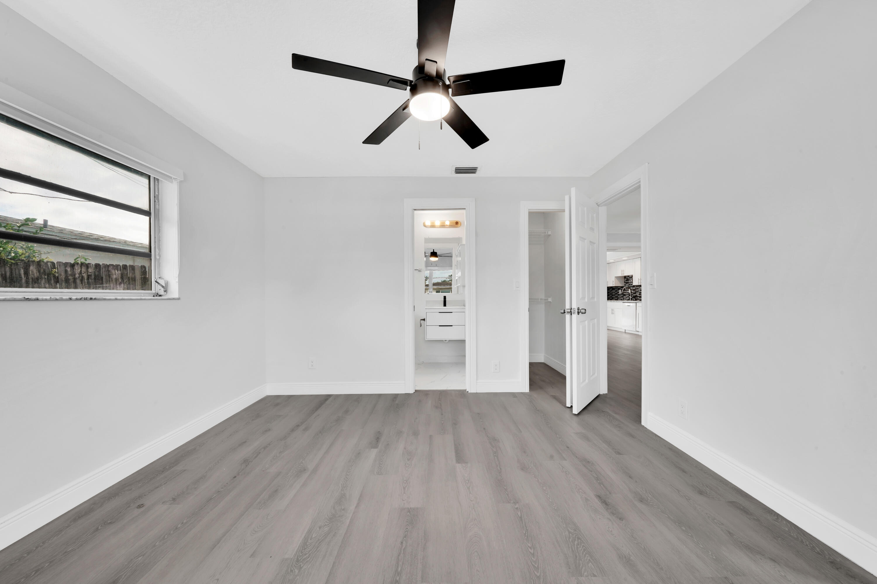 104 Palamino Circle Boca Raton, FL 33487 - Photo 13 of 34 a view of empty room with wooden floor and ceiling fan