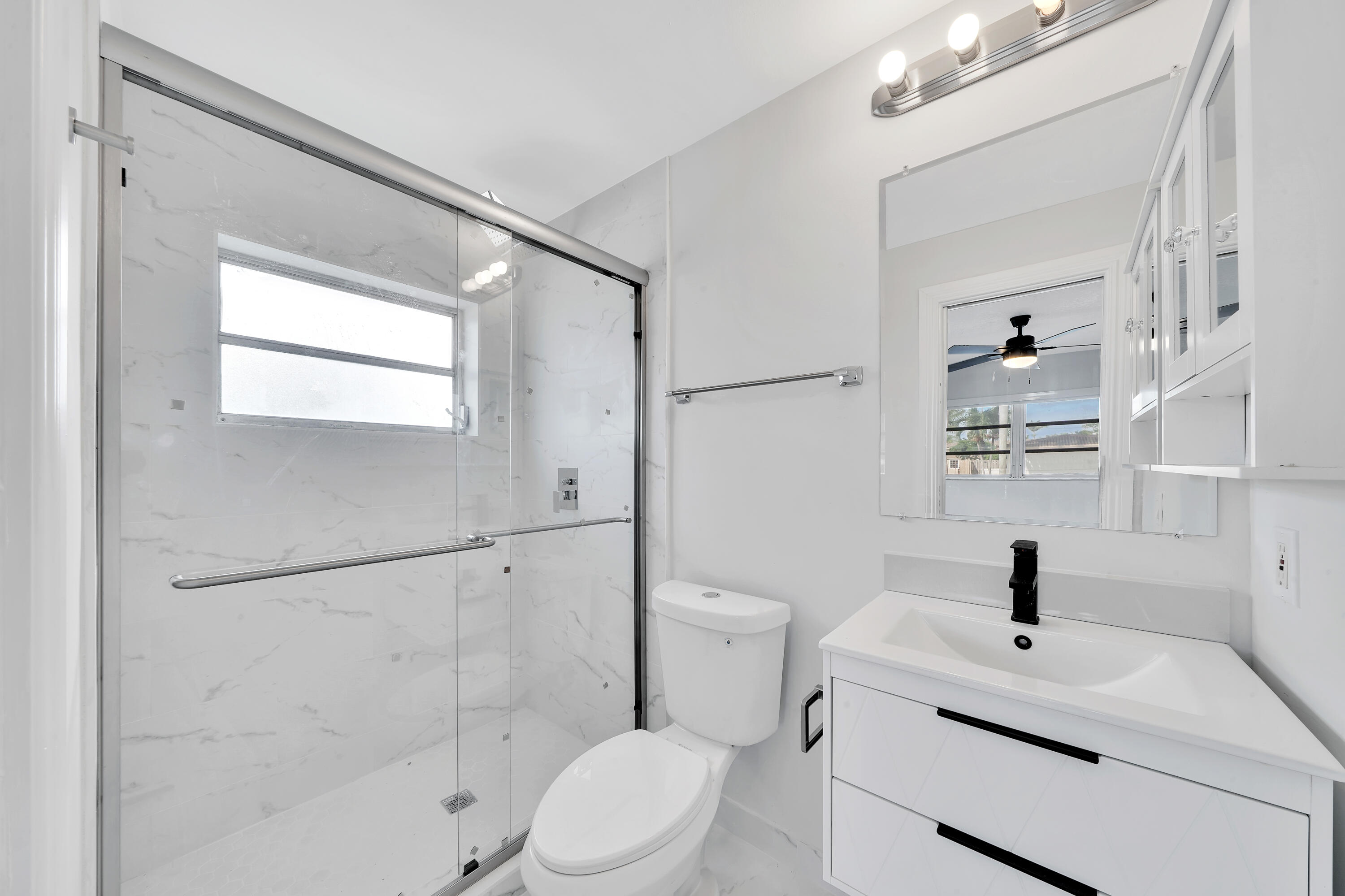 104 Palamino Circle Boca Raton, FL 33487 - Photo 15 of 34 a bathroom with a sink a toilet and shower