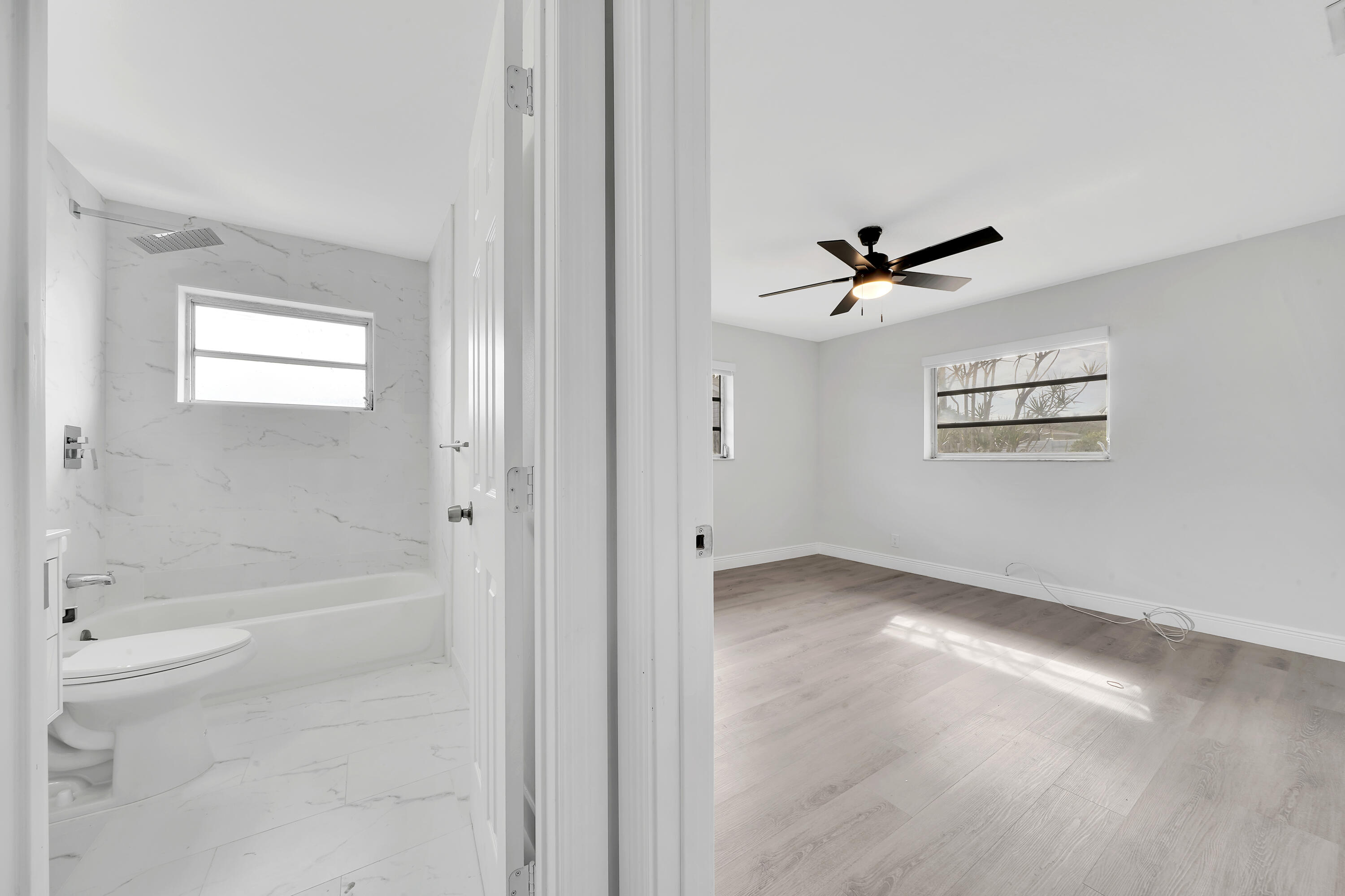 104 Palamino Circle Boca Raton, FL 33487 - Photo 16 of 34 a view of a livingroom with a ceiling fan and window