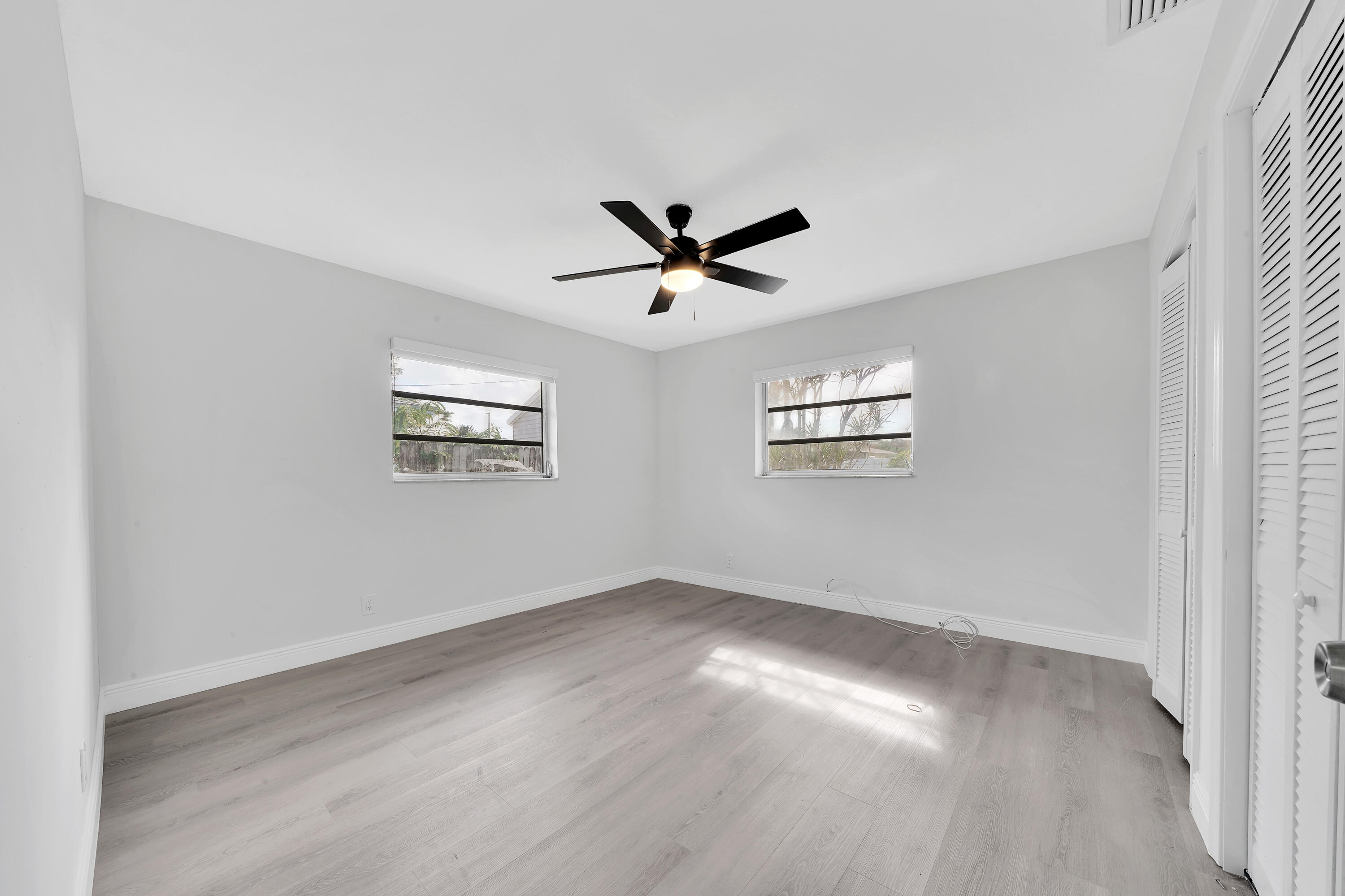 104 Palamino Circle Boca Raton, FL 33487 - Photo 17 of 34 an empty room with wooden floor and windows
