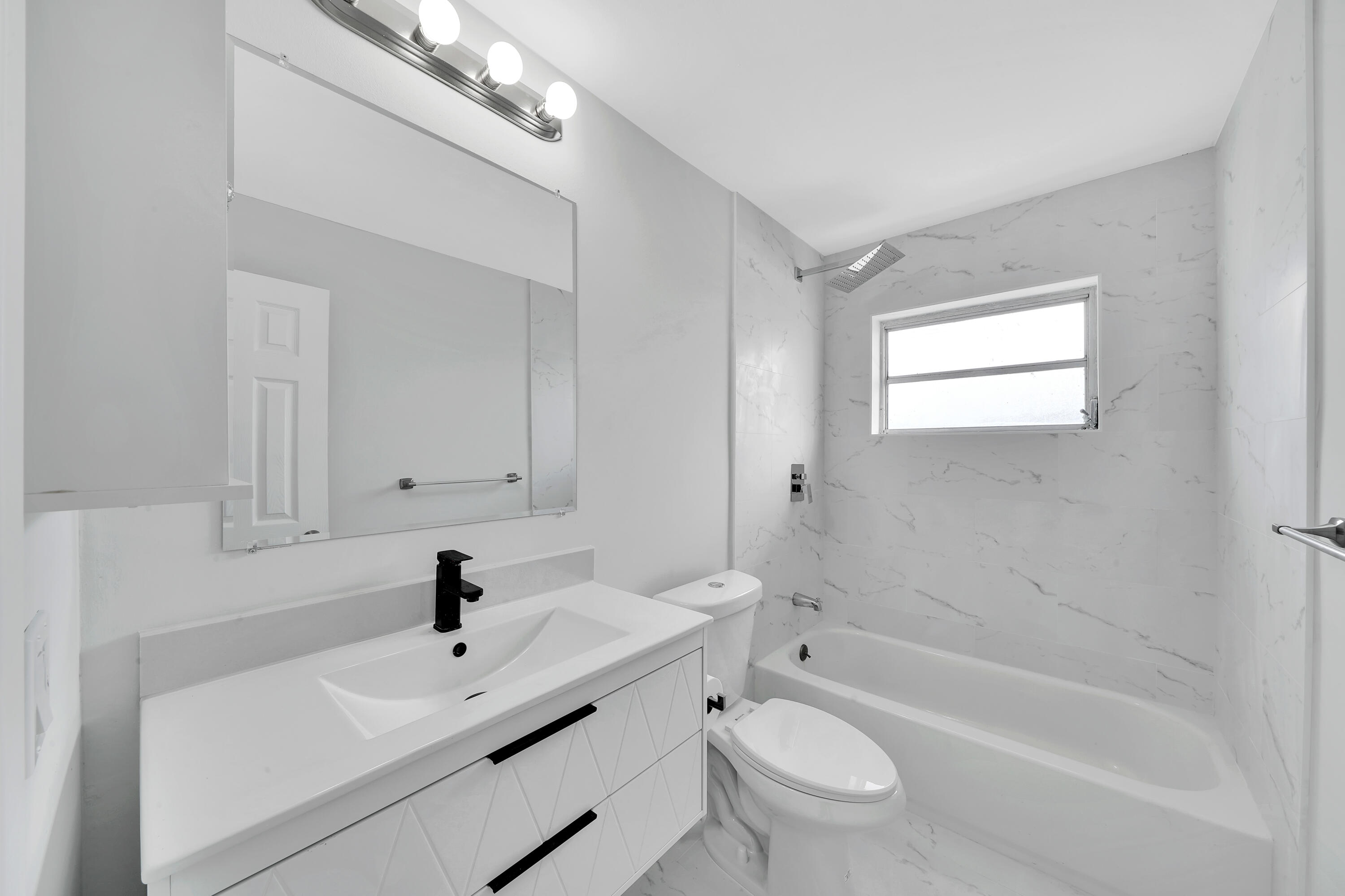 104 Palamino Circle Boca Raton, FL 33487 - Photo 20 of 34 a bathroom with a sink a toilet and a bathtub