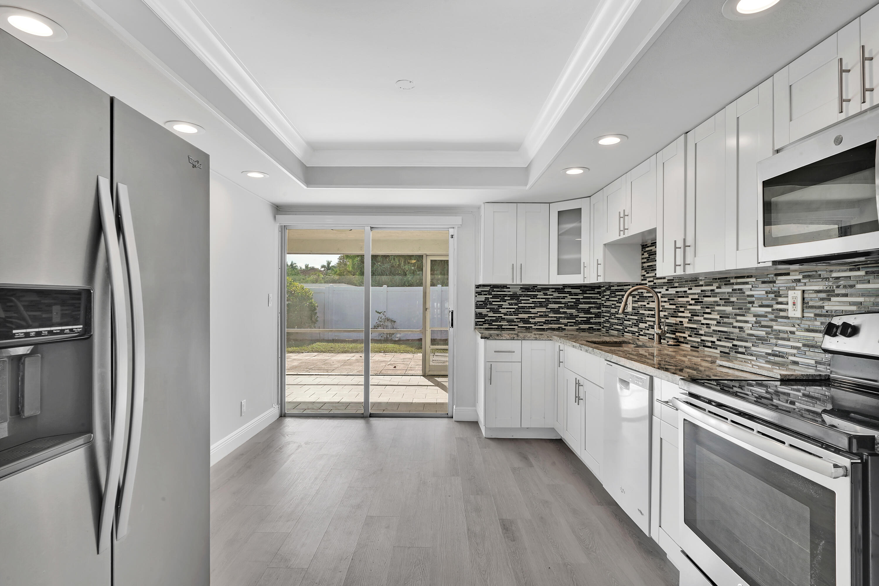 104 Palamino Circle Boca Raton, FL 33487 - Photo 2 of 34 a kitchen with stainless steel appliances granite countertop a refrigerator and a stove top oven
